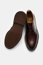 Officine Creative Chelsea Boot 'Dude Flexi' black shown from top and sole view, polished leather, Goodyear welted, tapered silhouette, side elastic, pull tab, leather lining, natural rubber outsole. Move versatilely through autumn and winter with the Chel
