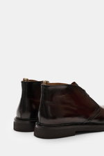 Rear side view of Officine Creative Chelsea Boot 'Dude Flexi' black in polished smooth leather with Goodyear welted, elastic inserts, pull tab, leather lining, and natural rubber outsole, perfect for autumn and winter versatility.