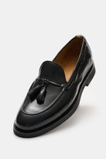 Officine Creative Tassel Loafer 'Opera Flexi' braun shown from a high angle, polished leather, slim silhouette, Goodyear-welted, tassel detail, grosgrain loop, leather lining, natural rubber sole.