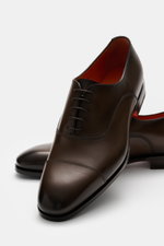 Santoni Oxford shoes dark brown shown from a close-up angled front perspective, featuring premium smooth leather, tapered silhouette, subtle colour gradient, closed five-eyelet lacing, cap toe, leather lining, leather outsole, and rubber-reinforced heel. 