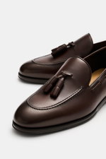 Henderson Tassel Loafer 'Moro Royal' dark brown shown from a close-up angled top view, featuring soft leather, tapered silhouette, elegant tassels, decorative toe stitching, Goodyear-welted, leather lining, rubber outsole, heel reinforcement, and practica