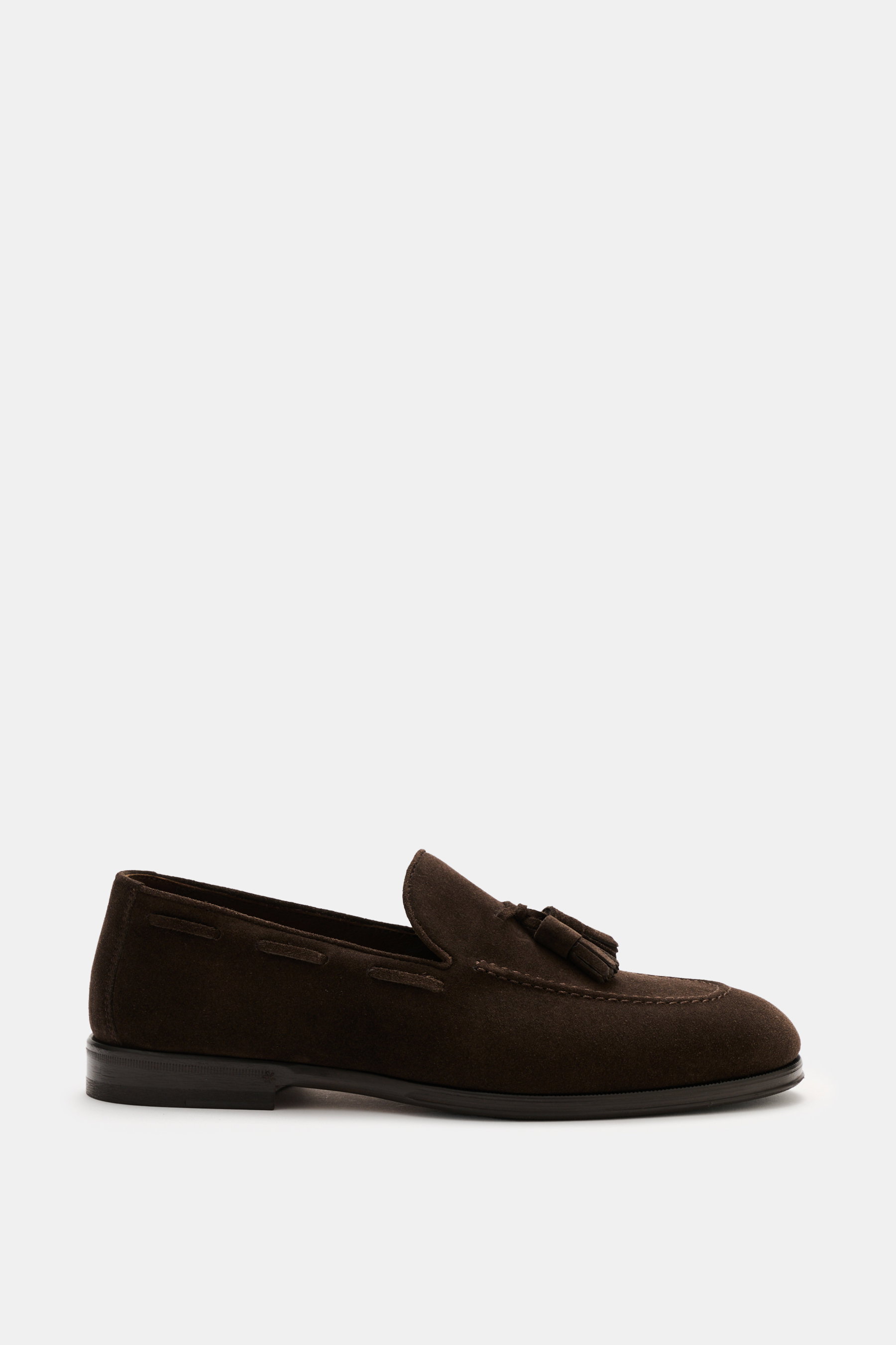 Henderson Tassel Loafer 'Modica' dark brown in supple suede leather, narrow silhouette, leather tassels, decorative toe stitching, Goodyear-welted, leather lining, rubber outsole with heel reinforcement, shown from side view with practical shoehorn.