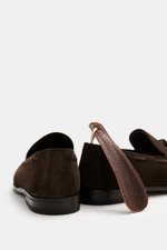 Henderson Tassel Loafer 'Modica' dark brown shown from rear angle, made of supple suede leather with narrow silhouette, leather tassels, decorative stitching, Goodyear-welted, leather lining, rubber outsole, heel with rubber reinforcement, and practical s