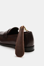 Henderson Penny Loafer 'Moro' dark brown shown from rear side, made of supple leather with narrow tapering silhouette and penny strap.
