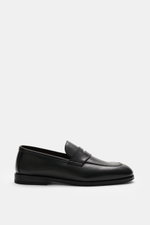 Henderson Penny Loafer 'Royal' black shown from side view, made of finely grained leather with typical penny strap, narrow tapering silhouette, decorative stitching on toe cap, Goodyear-welted, leather lining, rubber outsole, and heel with rubber reinforc