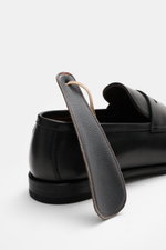 Rear close-up of the Henderson Penny Loafer 'Royal' black, showing finely grained leather, narrow tapering silhouette, and leather shoehorn. Stylish classic loafer with typical penny strap, decorative toe cap stitching, Goodyear-welted, leather lining, ru