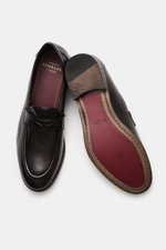 Top-down view of Sturlini Penny loafers 'Bufalo' dark brown, showing smooth leather, Blake-stitched design, tapered silhouette, signature penny strap, distinctive topstitching on toe cap, and leather-rubber outsole. 

<p>The 'Bufalo' penny loafers by STUR