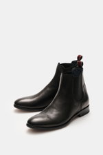 Front-side view of the Sturlini Chelsea boot 'Bufalo' black, made from noble smooth leather with elastic inserts and grosgrain pull loops.