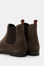 Close-up rear view of Sturlini Chelsea Boot 'Crosta Piuma' dark brown made of noble suede leather with elastic inserts, grosgrain pull tab, and Goodyear welted sole.