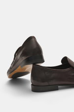 Rear and side view of The Row Loafer dark brown handcrafted in Italy from soft eel leather with a narrowing silhouette and leather sole.

Description: <p>Highest comfort from master craftsmanship: This loafer by THE ROW is handcrafted in Italy from supple