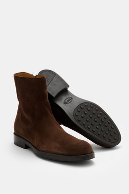 Tod's Ankle boot dark brown in noble suede leather with slightly slim tapering silhouette, side zipper, high shaft, leather lining, and lightly profiled rubber sole, shown from a three-quarter front and bottom perspective.