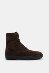 Side view of Tod's Lace-up boots brown in soft suede with a slightly tapered cut, seven-eyelet lacing with hooks and eyelets, lambskin lining, and signature nubbed rubber sole.