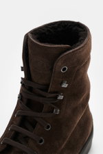 Tod's Lace-up boots brown shown from a close-up top front angle, featuring soft suede, slightly tapered cut, seven-eyelet lacing with hooks and eyelets, lambskin lining, and signature nubbed rubber sole.