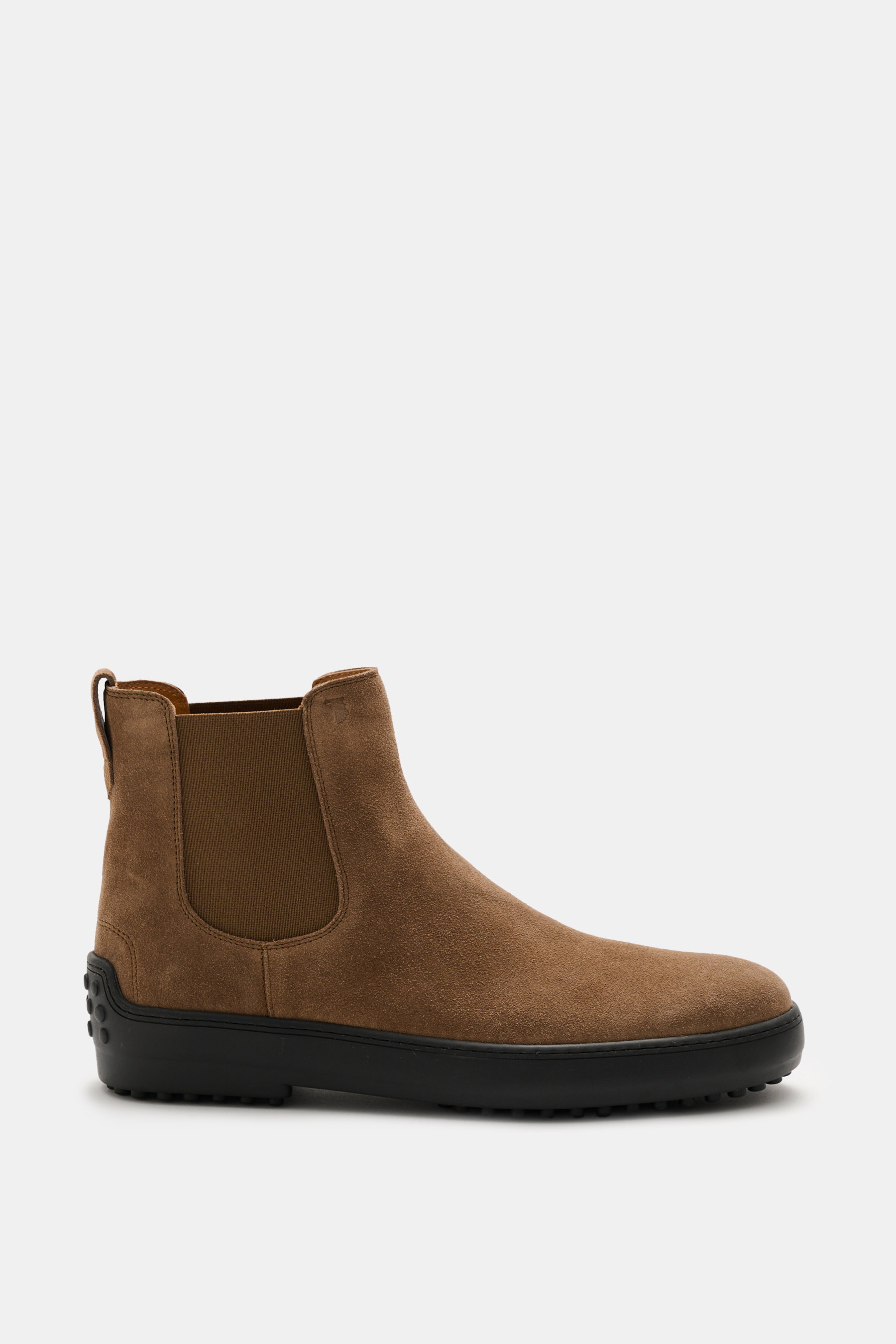 Side view of Tod's Chelsea Boot light brown in soft suede leather, slightly narrow tapered with side elastic inserts, leather lining, practical pull tab, and typical studded rubber sole.