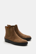 Front-side view of Tod's Chelsea Boot light brown in soft suede leather, slightly narrow tapered with side elastic inserts, leather lining, practical pull tab, and typical studded rubber sole.