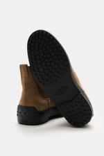 Tod's Chelsea Boot light brown shown from the sole and back side, featuring soft suede leather, slightly narrow tapered shape, side elastic inserts, leather lining, practical pull tab, and typical studded rubber sole.