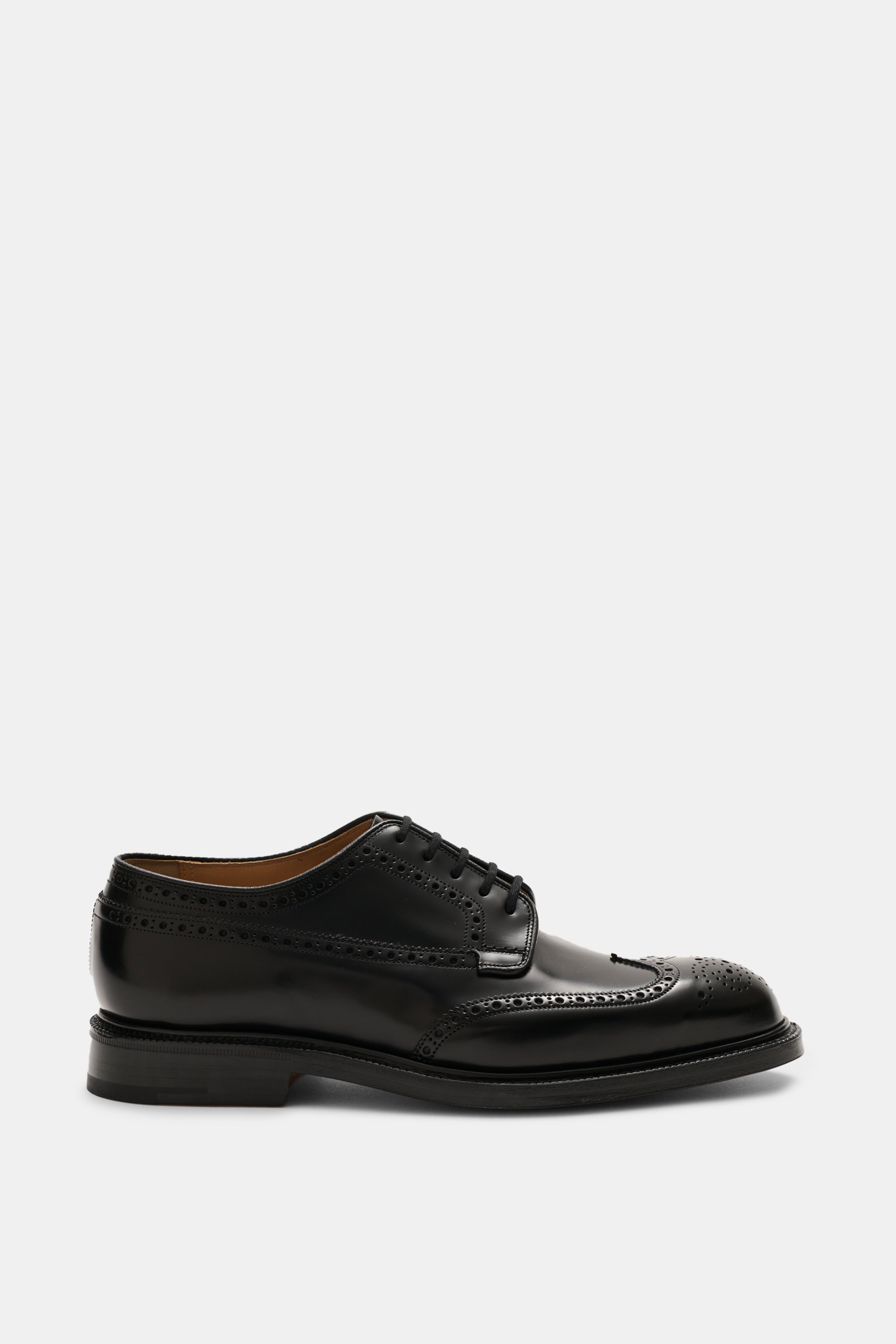 Side view of Church's Fullbrogue black men's shoe in premium smooth calf leather with noble broguings, wingtip, open five-eyelet lacing, leather lining and outsole, Goodyear welt construction, and rubber-reinforced heel, made in England.