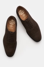 Church's Oxford 'Consul' dark brown suede shoes seen from above, with applied front cap, closed five-eyelet lacing, rubber heel, leather sole and lining, Goodyear-welted, narrow tapering shape, fine suede leather.