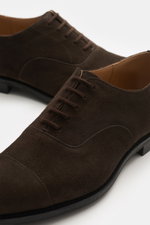 Close-up front and side view of Church's Oxford 'Consul' dark brown suede shoes with applied front cap and five-eyelet lacing.

Description: <p>With this simple Oxford made of finest suede leather with an applied front cap and practical rubber reinforceme