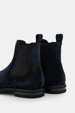 Close-up rear side view of Fabiano Ricci Chelsea Boot navy in noble suede leather with elastic inserts and pull tab.

<p>This sporty Chelsea boot made of noble suede leather by FABIANO RICCI is perfect for the transitional season: the lightweight, studded