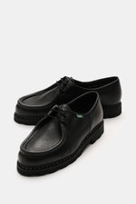 Paraboot Lace-up shoes 'Michael' black shown from a front-side angle, featuring grained smooth leather, Norwegian welt seam, moc-toe design, two-eyelet lacing, woven label, leather lining, and durable natural rubber outsole.