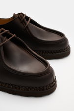 Paraboot Dress shoes 'Michael' dark brown shown from a close-up front-side angle, featuring fine nubuck leather, Norwegian welted design, tapered cut, two-eyelet lacing, subtle woven label, leather lining, and robust natural rubber sole. A timeless classi