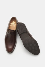 Crockett & Jones Monk 'Monkton' dark brown shoes shown from top and sole view, polished smooth leather, buckle, stitched sole, narrow silhouette, rubber outsole.