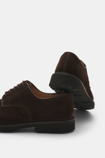 Crockett & Jones Derby 'Windermere' dark brown suede shoes shown from a rear side angle with slim silhouette, five-eyelet lace, leather lining, and profiled rubber sole. A classic men's shoe for autumn with soft suede leather and monochrome look.
