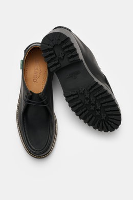 Top view of Sebago Wallabee 'Dockside' black shoes showing sturdy nubuck leather, round silhouette, typical decorative seam, two-eyelet lacing on instep, leather lining, and sturdy rubber sole with tread. Practical for transitional season.