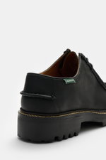 Close-up rear side view of Sebago Wallabee 'Dockside' black shoe in sturdy nubuck leather with round silhouette, decorative seam, two-eyelet lacing, leather lining, and rubber sole with tread, practical for transitional seasons.