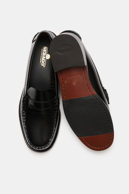 Top-down view of Sebago Penny loafers 'Classic Dan' black, showing finely grained leather, signature penny strap, decorative toe stitching, leather lining, through-sewn Blake-stitched finish, leather outsole with natural rubber heel reinforcement.