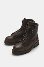 Front-side view of Brunello Cucinelli Dark Brown Lace-Up Boot made of grained and suede leather with high ten-eyelet lacing, logo patch on tongue, leather lining, and profiled rubber sole.

Description: 
<p>Robust lace-up boot by BRUNELLO CUCINELLI: This 