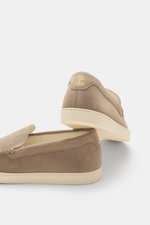 Rear and side view of a beige Brunello Cucinelli Loafer made of soft suede leather, featuring embossing, decorative seam, tapered shape, light unlined construction, and rubber outsole. 

Description: <p>A loafer by BRUNELLO CUCINELLI that embodies stylish
