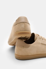 Rear and side view of Zegna Sneakers sand in smooth suede with round toe cap, seven-eyelet lacing, leather lining, and flexible rubber sole.

These timeless sneakers in supple suede by ZEGNA combine a deconstructed silhouette with a successful balance bet