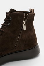 Officine Creative Lace-up boot 'Frame' dark brown shown from side close-up, noble suede leather, tapered silhouette, five-eyelet lacing, two lace hooks, grosgrain pull loop, leather lining, side zipper, lightweight rubber outsole.