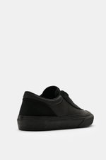 Stone Island Sneakers black shown from the side with canvas and suede leather, round toe cap, five-eyelet lacing, logo patch on tongue, textile lining, all-around rubber coating, and durable rubber sole.