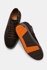 Top-down view of Santoni High Top Sneaker 'Dump' dark brown in supple suede leather with textile lining, round toe cap, eight-eyelet lacing, side zipper, emblem on the tongue, contrasting stitching details, and comfortable rubber sole with orange accents.