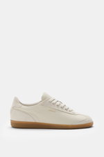 Side view of Axel Arigato Sneaker 'Zane' creme in finely grained leather with suede overlays, round toe, seven-hole lacing, padded collar, terry and leather lining, and flexible gum sole, featuring gold foil branding. <div class="qMYqUG_convSearchResultHi