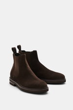 Front side view of Henderson Chelsea boots dark brown in premium suede with elasticated inserts, pull-on tab, Blake design, and treaded Vibram sole.
