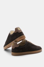Rear and side view of Brunello Cucinelli Sneakers grey brown in supple suede with slightly tapered silhouette, patch wing cap, seven-eyelet lacing, smooth leather tab with embossed label, padded topline with logo print, smooth leather lining, and natural 