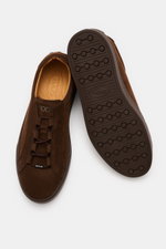Top and sole view of Tod's Slip-on Sneaker dark brown made of soft suede leather with elastic lacing, padded collar, emblem on tongue, and studded rubber sole.