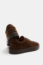 Rear and side view of Tod's Slip-on Sneaker dark brown in soft suede leather with studded rubber sole and emblem on tongue.

Description:  
<p>The slip-on sneaker is indispensable this season. TOD'S sets the example with this model, combining stylish desi