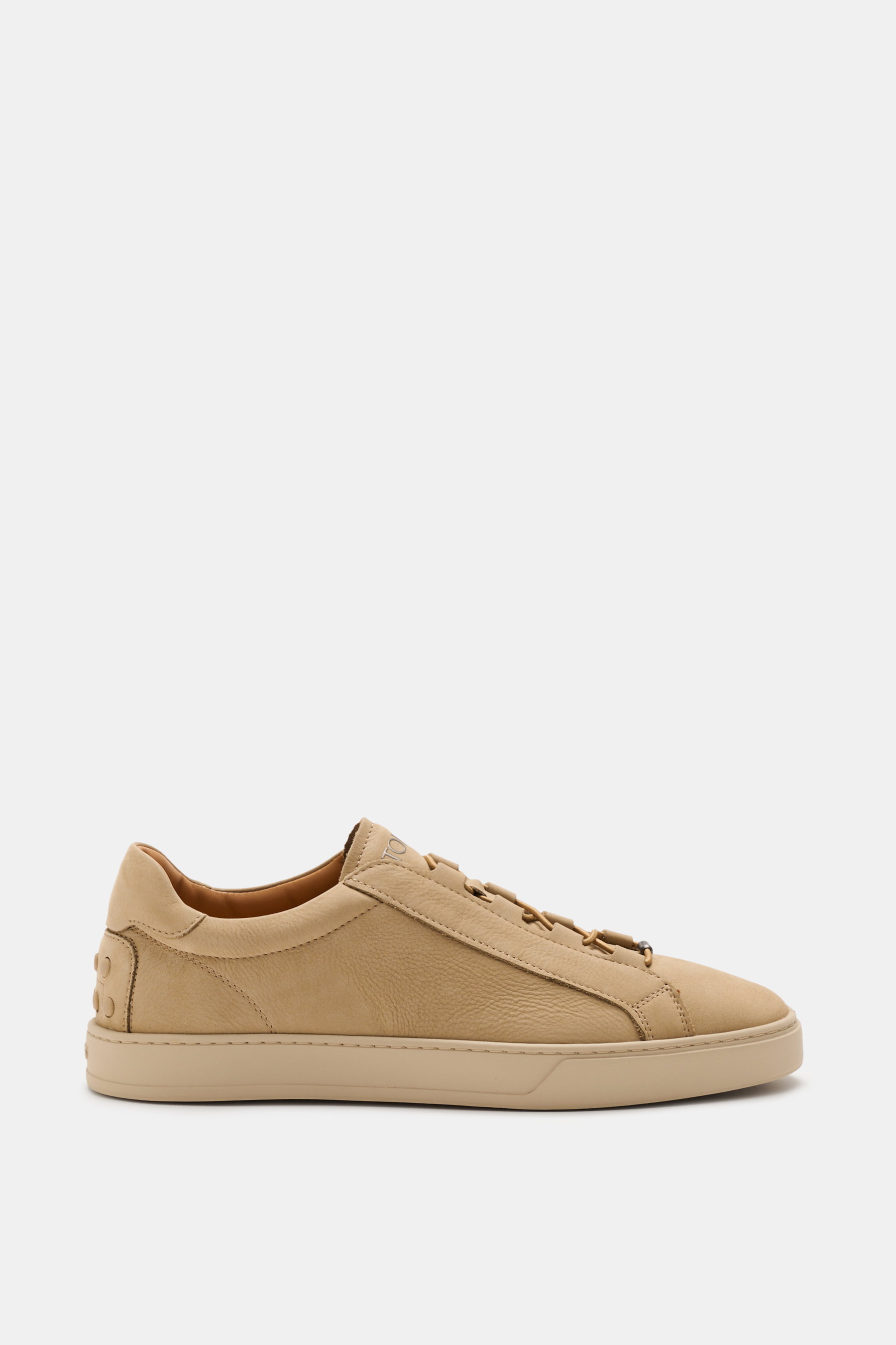 Side view of Tod's Slip-on Sneaker beige in soft suede leather with elastic closed lacing, padded collar, emblem on tongue, leather and textile lining, and studded rubber sole, combining style and comfort for a pleasant walking experience.