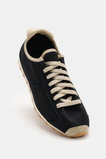 Close-up front-angle view of the Jacquemus Sneaker 'Les Tennis' black/beige featuring durable canvas, seven-hole lacing, shoe tongue with logo embossing, canvas overlays, leather lining, and an ultraflexible rubber sole.
