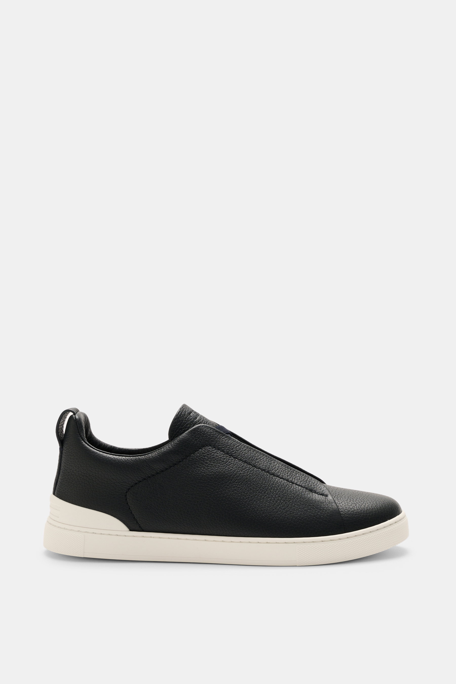 Zegna Slip-on Sneaker 'Triple Stitch' navy shown from side view, made of grained leather with round toe cap, crisscrossed elastic bands, high padded collar, pull tab, tongue with ZEGNA embossing, leather lining, and flexible rubber sole. Inspired by iconi