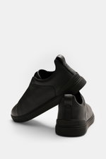 Close-up rear and side view of Zegna Slip-on Sneaker 'Triple Stitch' black, made of grained leather, featuring round toe, crossed elastic bands, high padded collar, pull tab, embossed tongue, leather lining, and flexible rubber sole.