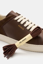 Close-up side view of Axel Arigato Sneaker 'Clean 90 Split' dark brown with smooth and suede leather, seven-eyelet lacing, and gold embossing.
