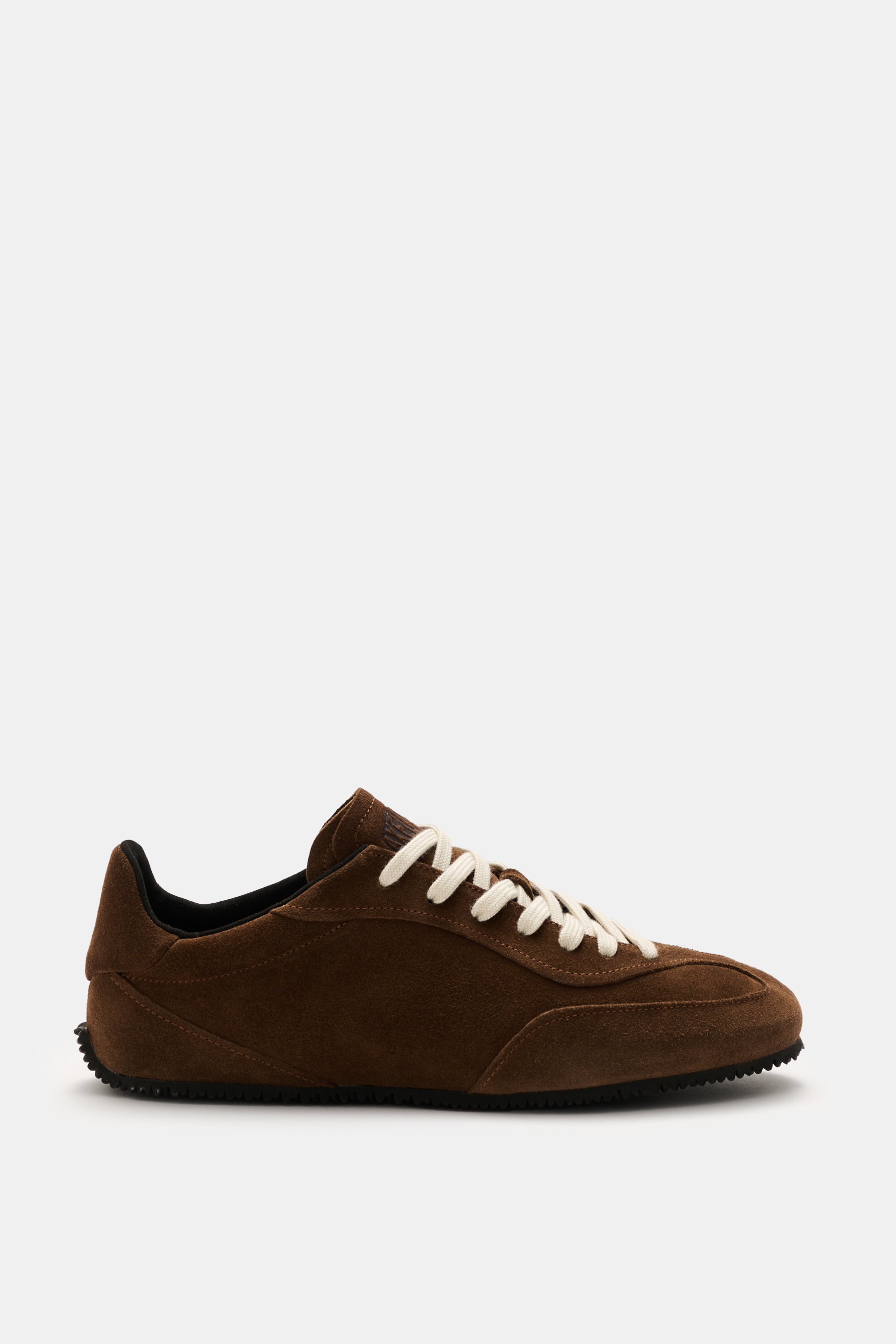 Side view of Axel Arigato Sneaker 'Daze Runner' dark brown in supple suede leather with tonal overlays, rounded toe cap, seven-eyelet lacing, padded collar, terry lining, and flexible rubber sole, handmade in Portugal.