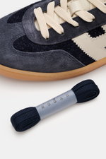 Close-up top-side view of Hogan Sneaker 'Cool Allacciato' dark brown/off-white showing supple suede leather, seven-hole lacing, contrast overlays, logo tongue, and flexible gum sole with extra navy laces. Walk like on clouds: The sneaker 'Cool Allacciato'