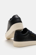 Rear and side close-up of Filling Pieces Sneaker 'Teabreak Waxed' navy showing grained leather, round toe cap, seven-eyelet lacing, padded collar, side logo embossing, perforated leather lining, and rubber sole, photographed from a low angle.

<p>The snea